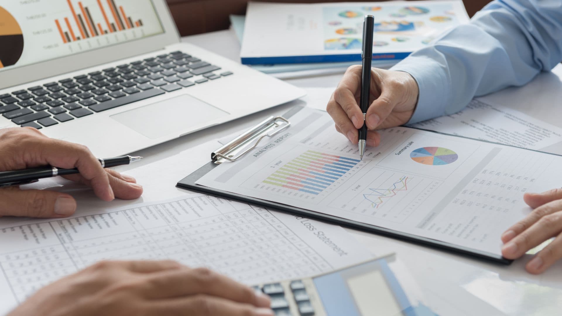 Actuaries reviewing financial analysis reports